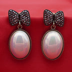 Gold Tone Bow Pearl Drop Earrings