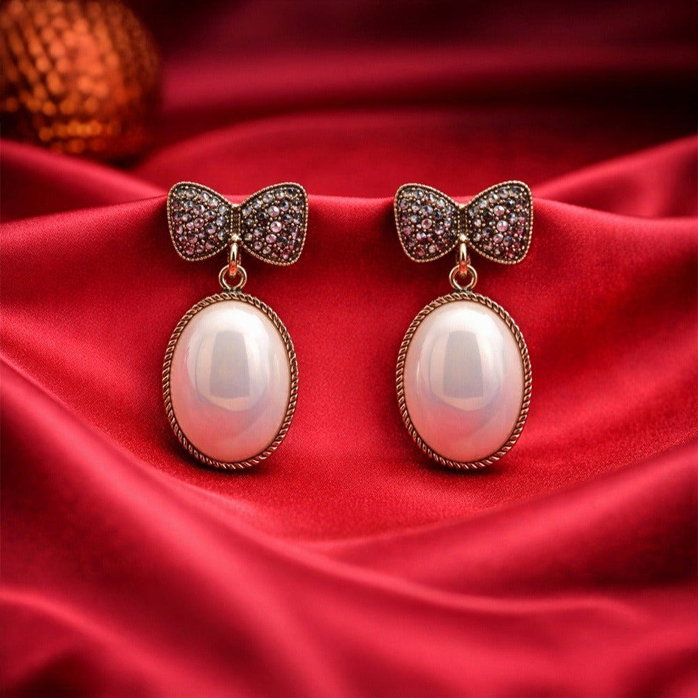 Gold Tone Bow Pearl Drop Earrings