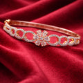 Structured Gold-Tone Bracelet with Floral Motif Center and Diamond-Lined Circles (Free Size)